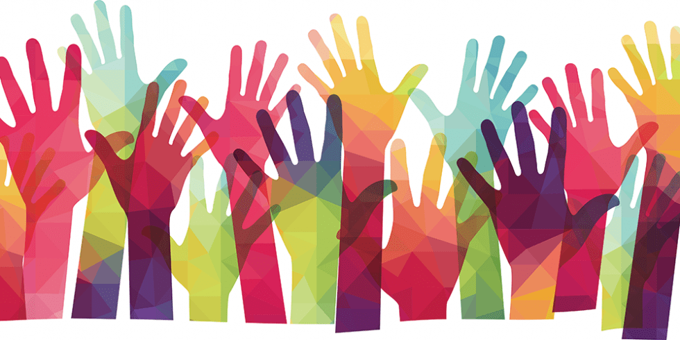 A group of colorful hands are reaching up in the air.