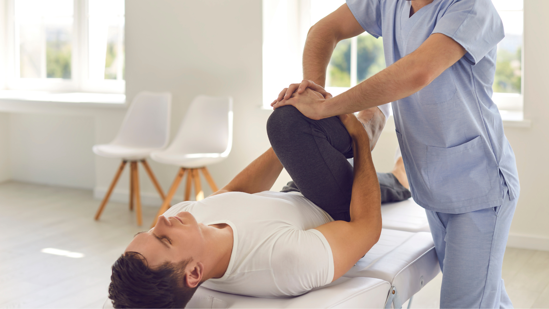 a man is laying on a table getting a massage from a nurse .
