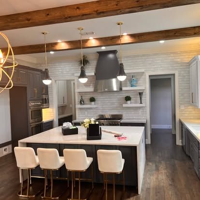A kitchen with a large island and stools
