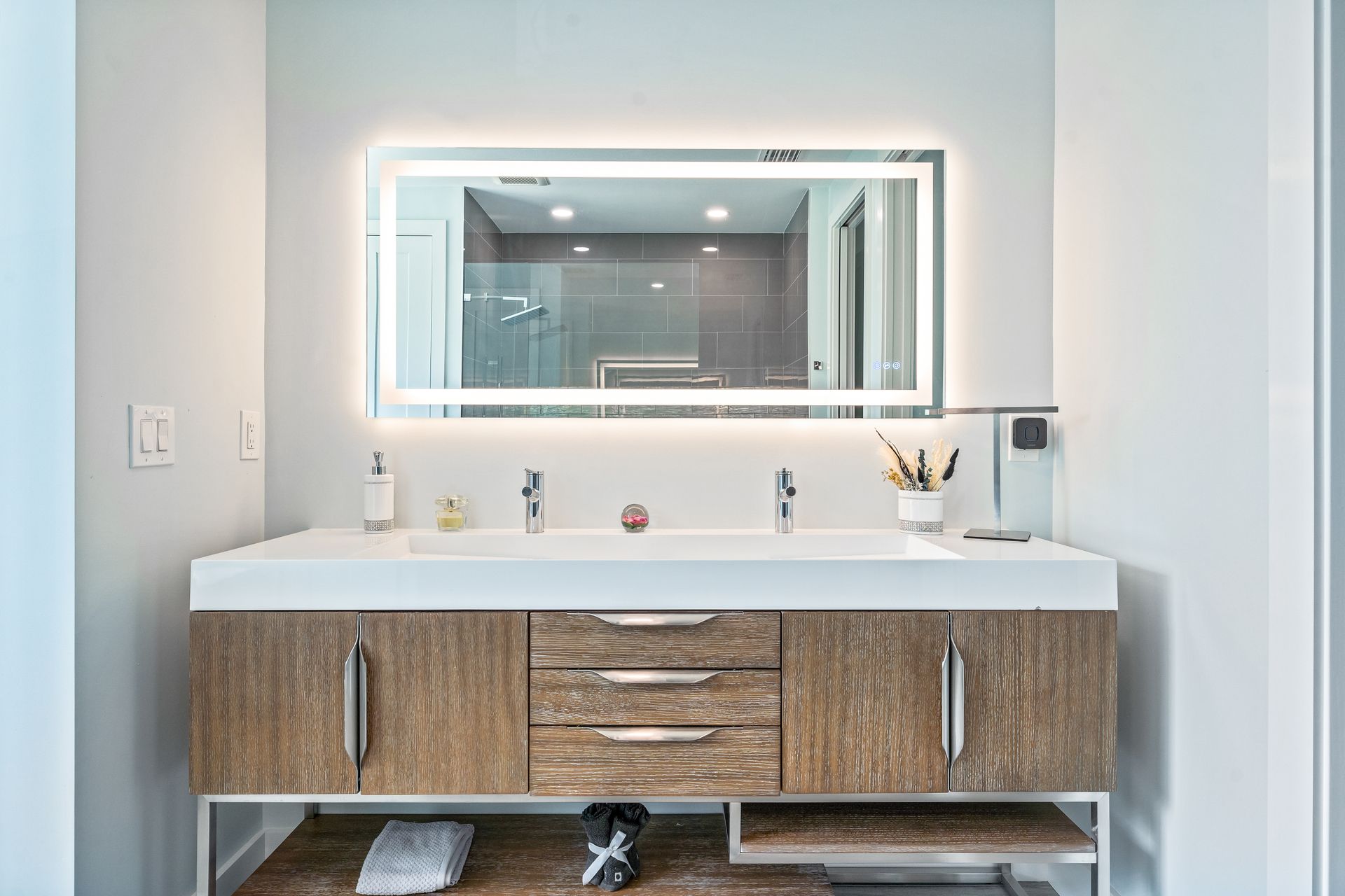A bathroom with a double sink and a large mirror.