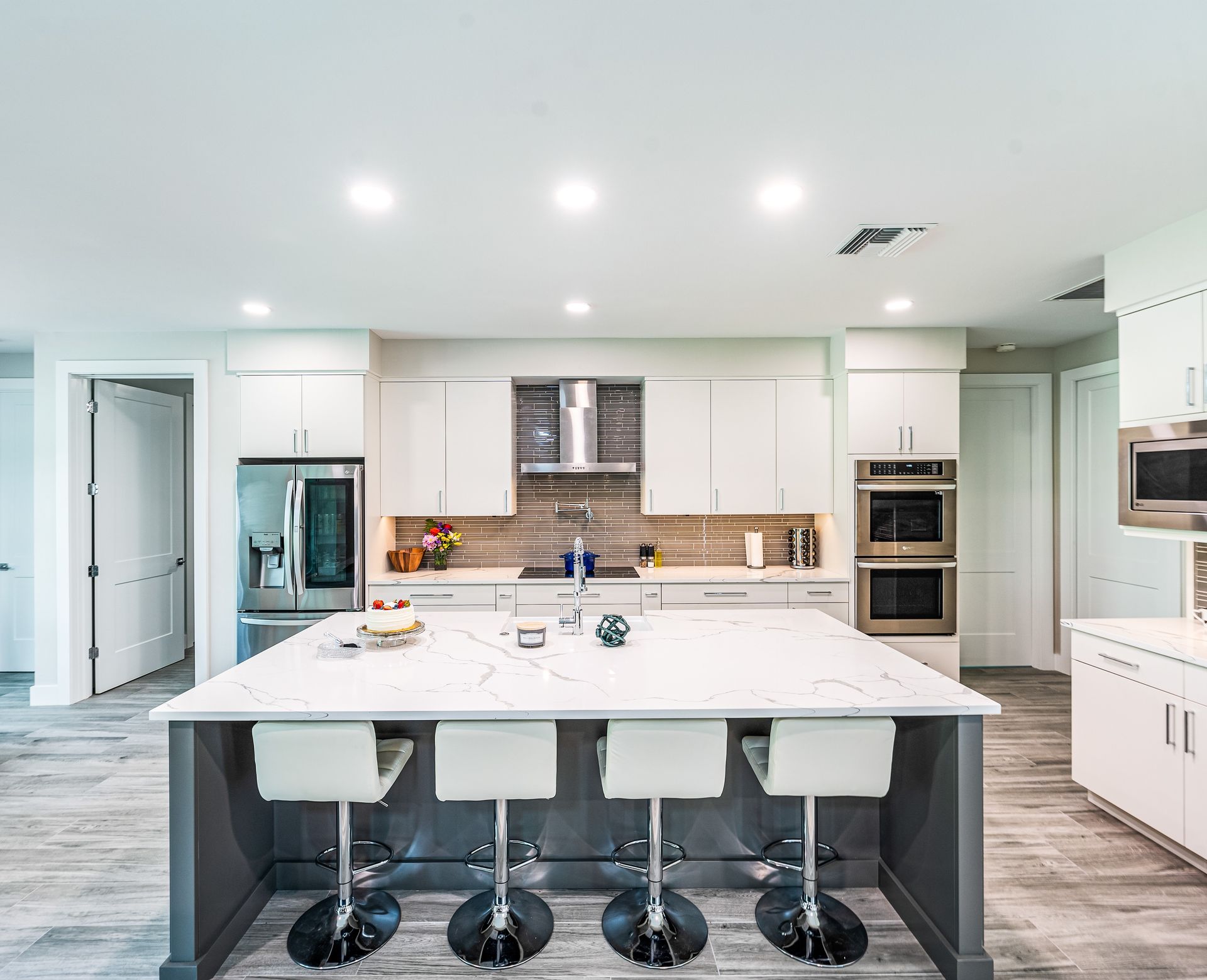 A kitchen with a large island and stools.