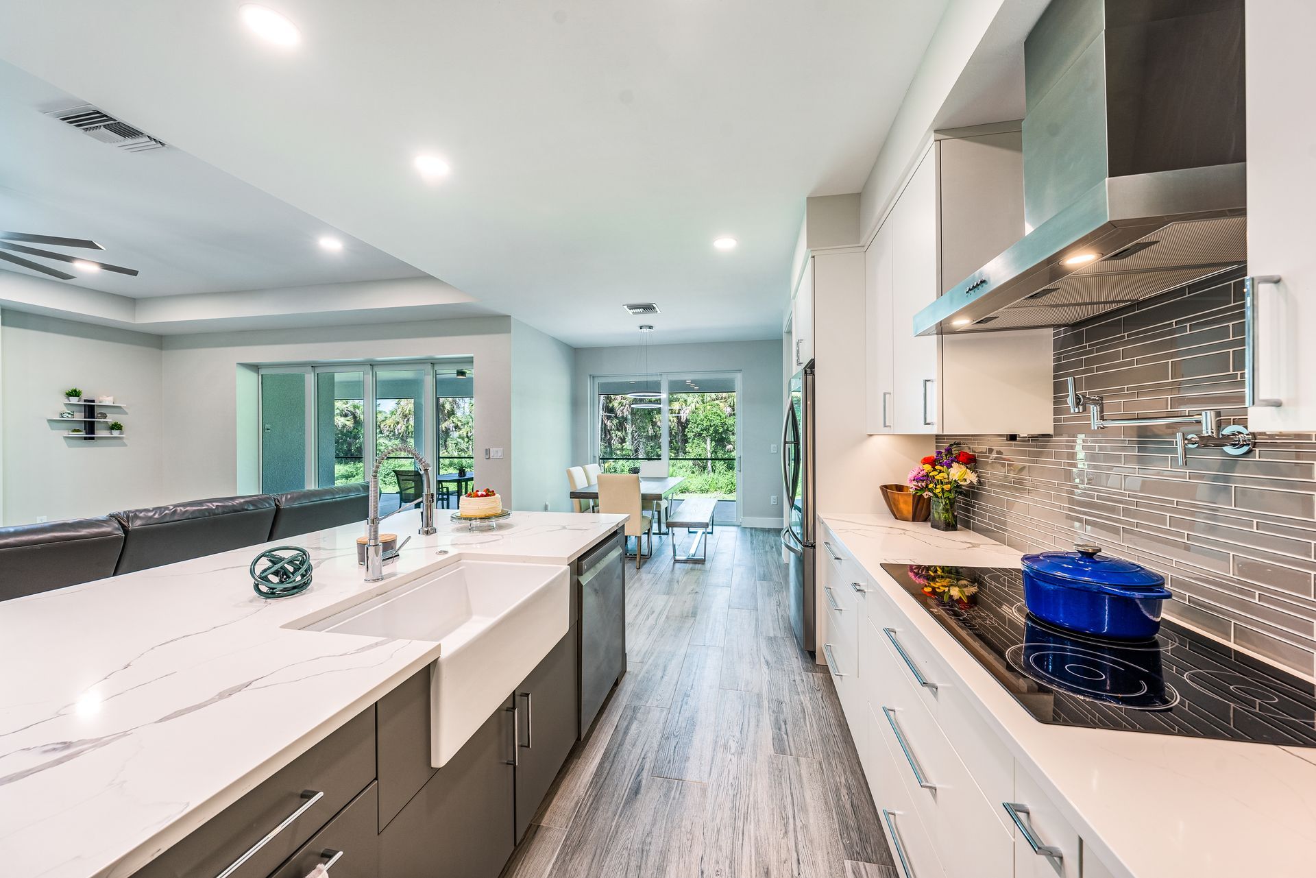 A kitchen with a pot on the stove and a sink.