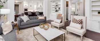 A living room filled with furniture and a coffee table. A living room filled with furniture and a coffee table.