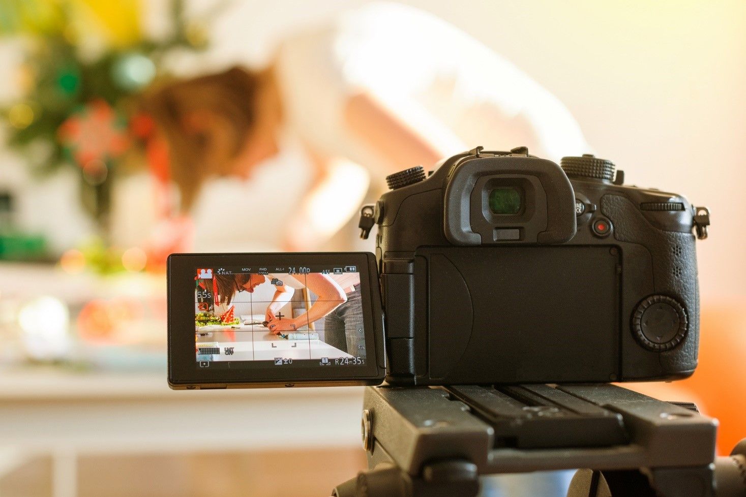 A camera is sitting on a tripod and recording a video. A camera is sitting on a tripod and recording a video.