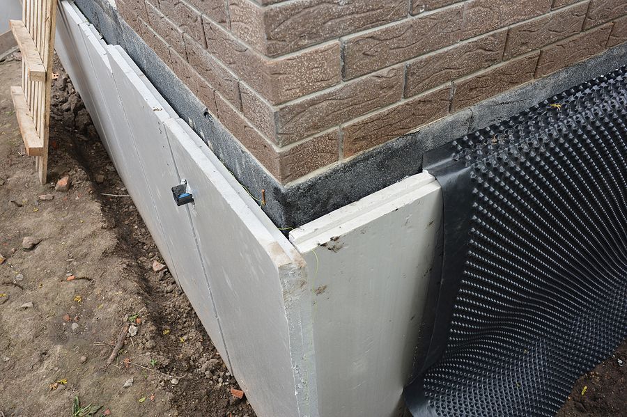 a close up of a brick wall with a metal grate
