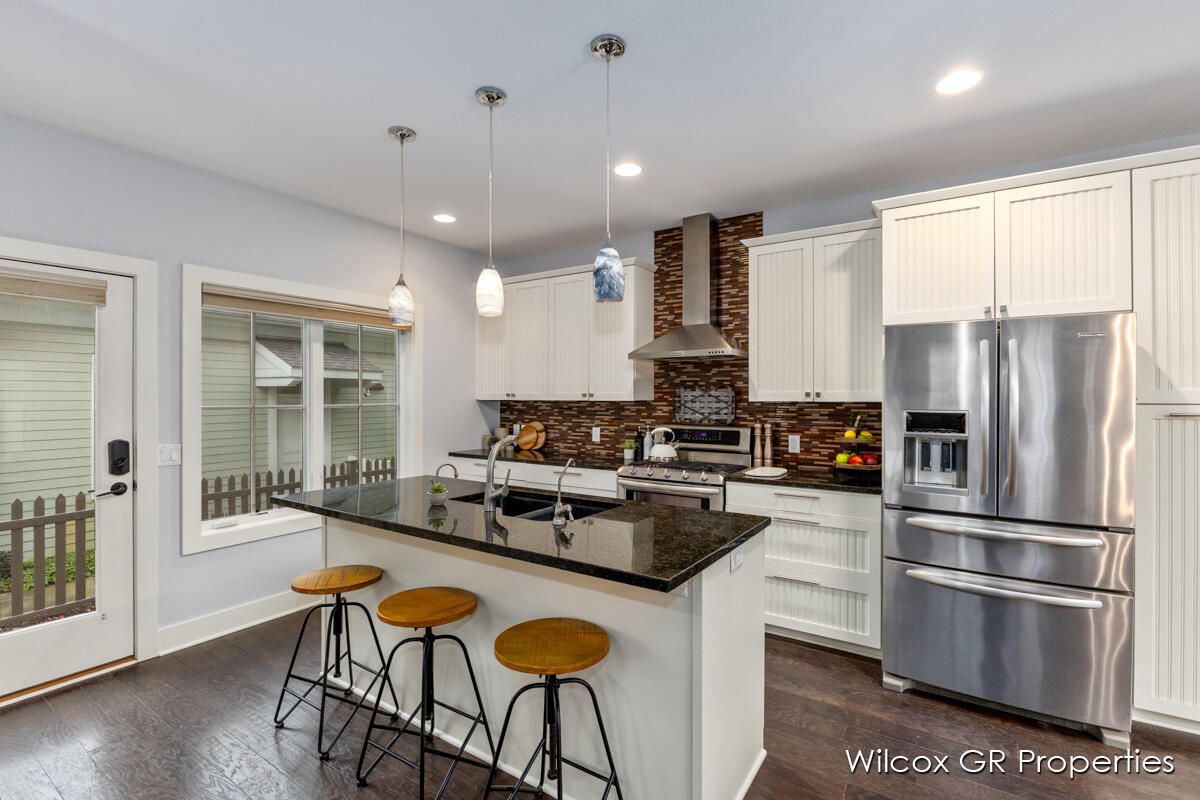 A kitchen with stainless steel appliances and white cabinets