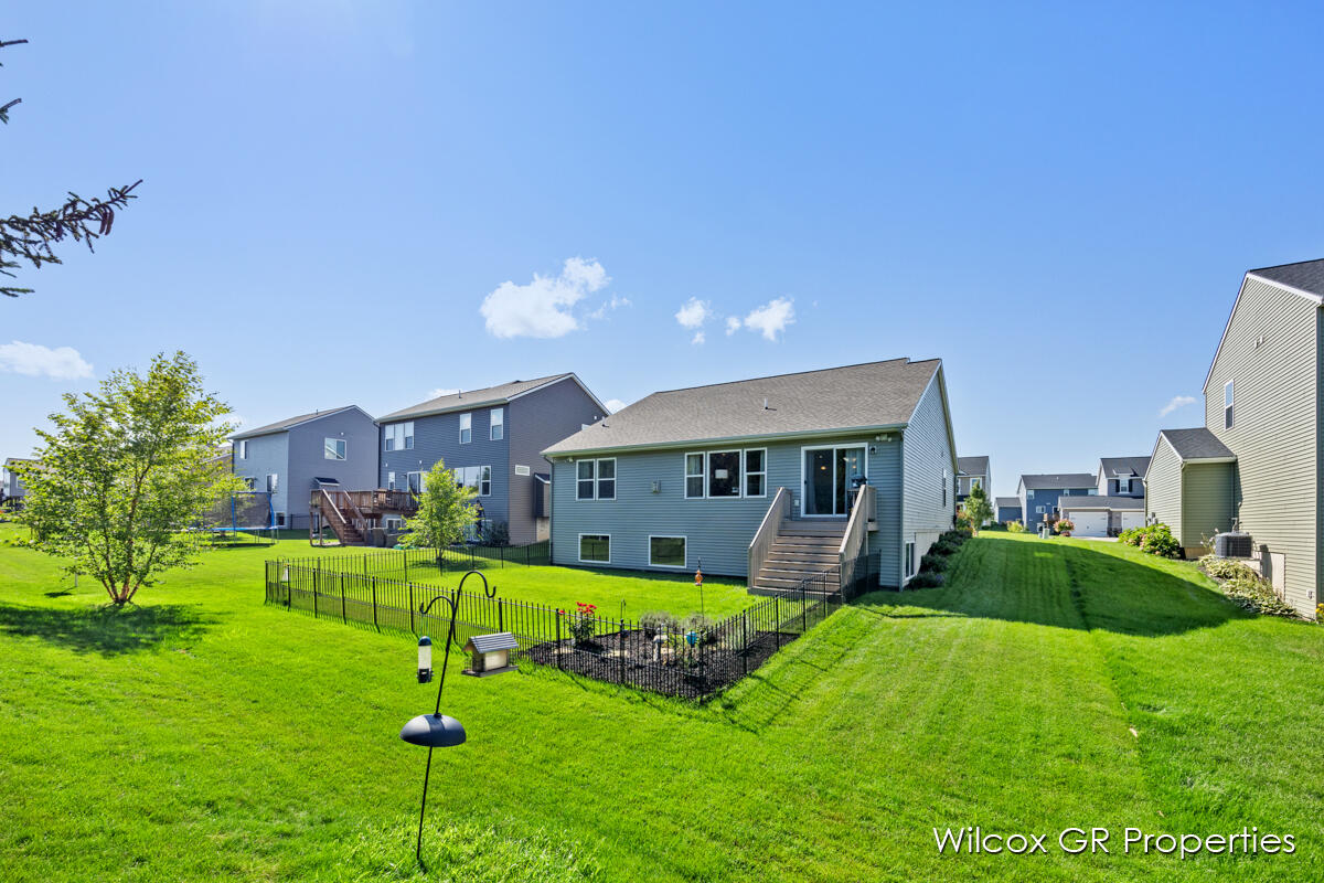 7849 High Knoll Drive is sitting on top of a lush green lawn in a residential area.
