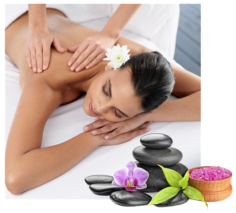 Spa massage with woman lying face down, flower in hair, and stacked black stones with orchid and candles