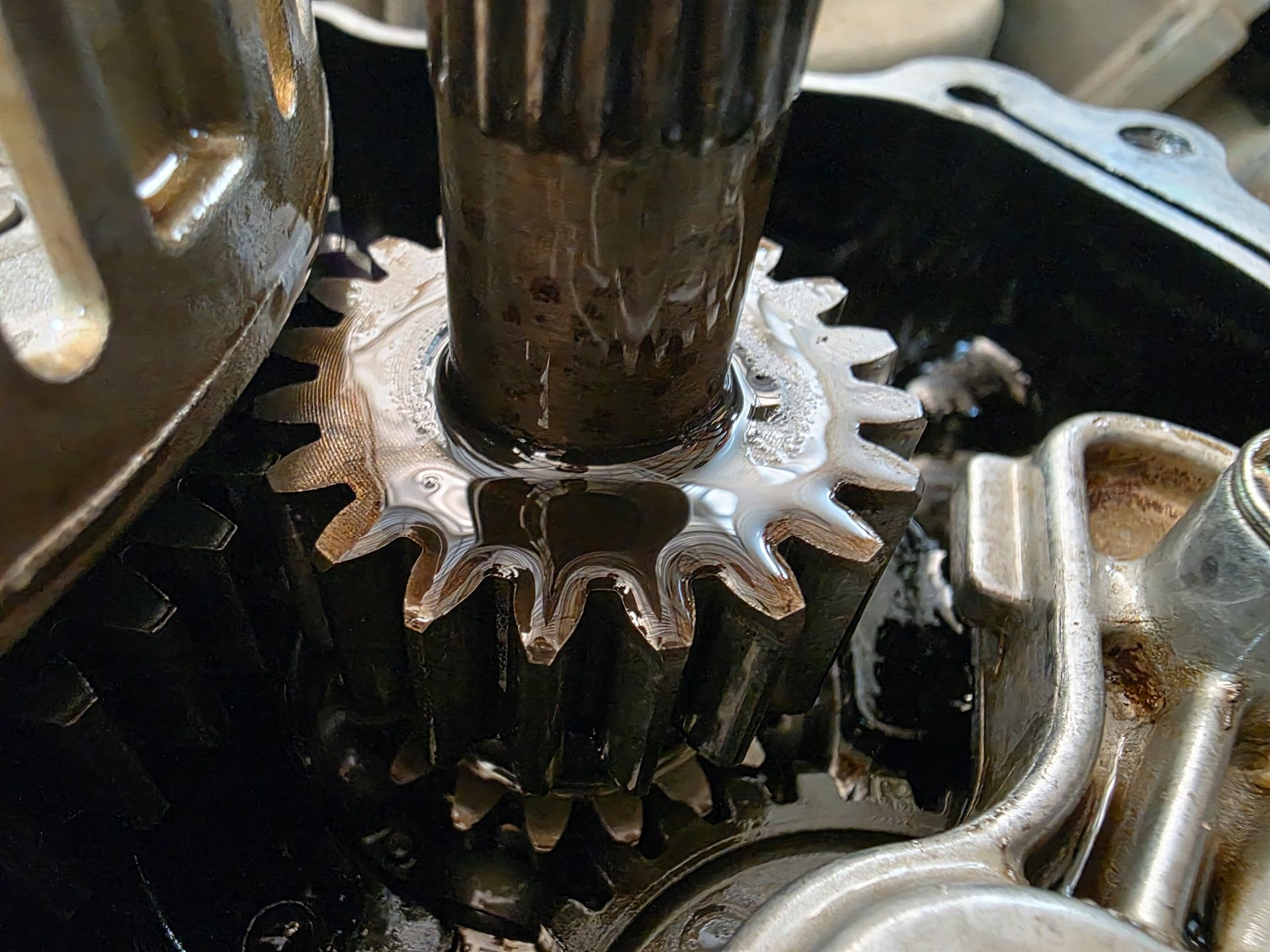 Close up of metallic car gears needing a professional transmission fluid exchange service.