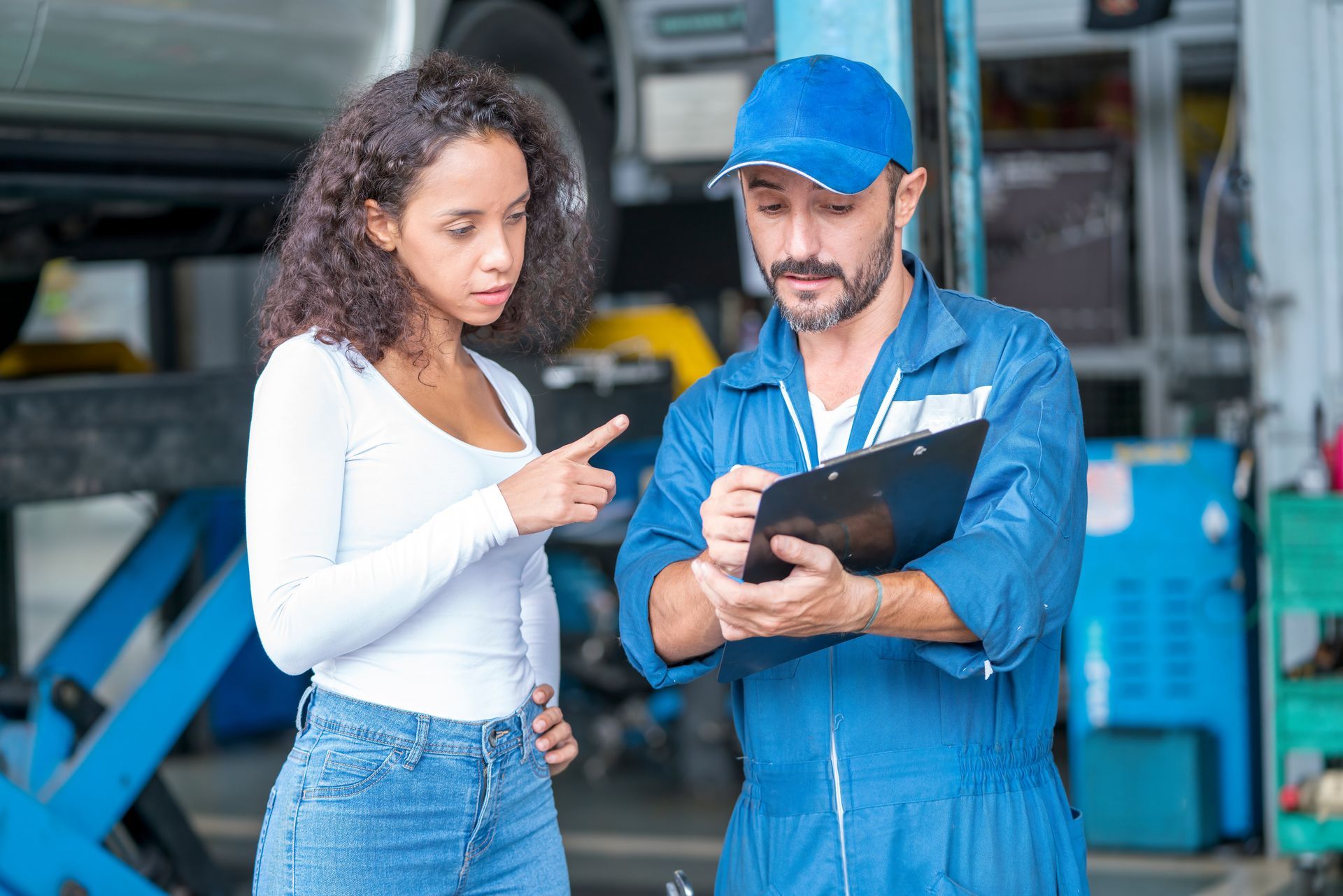 Mechanic explaining auto transmission repair findings to a customer