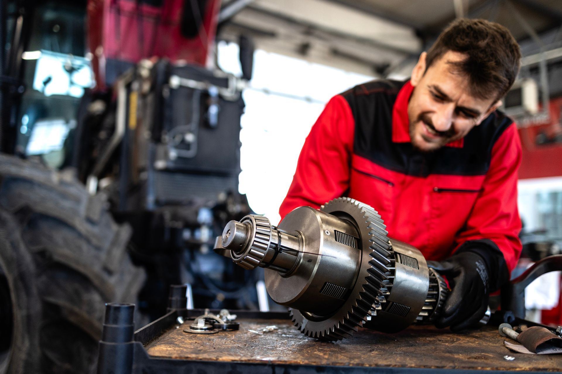 Experienced mechanic repairing and servicing transmission gears.
