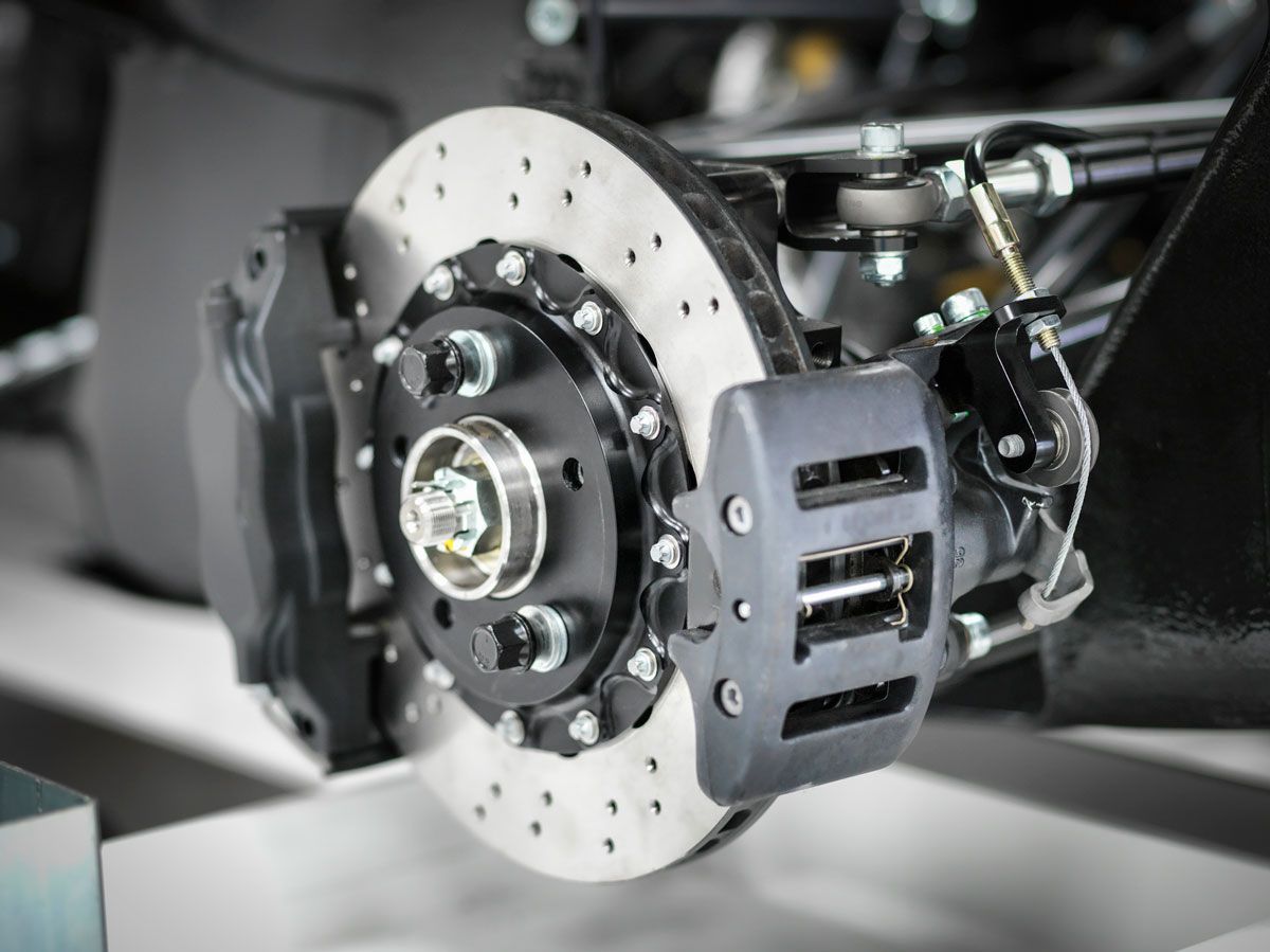 Car brake system with a perforated rotor and caliper.