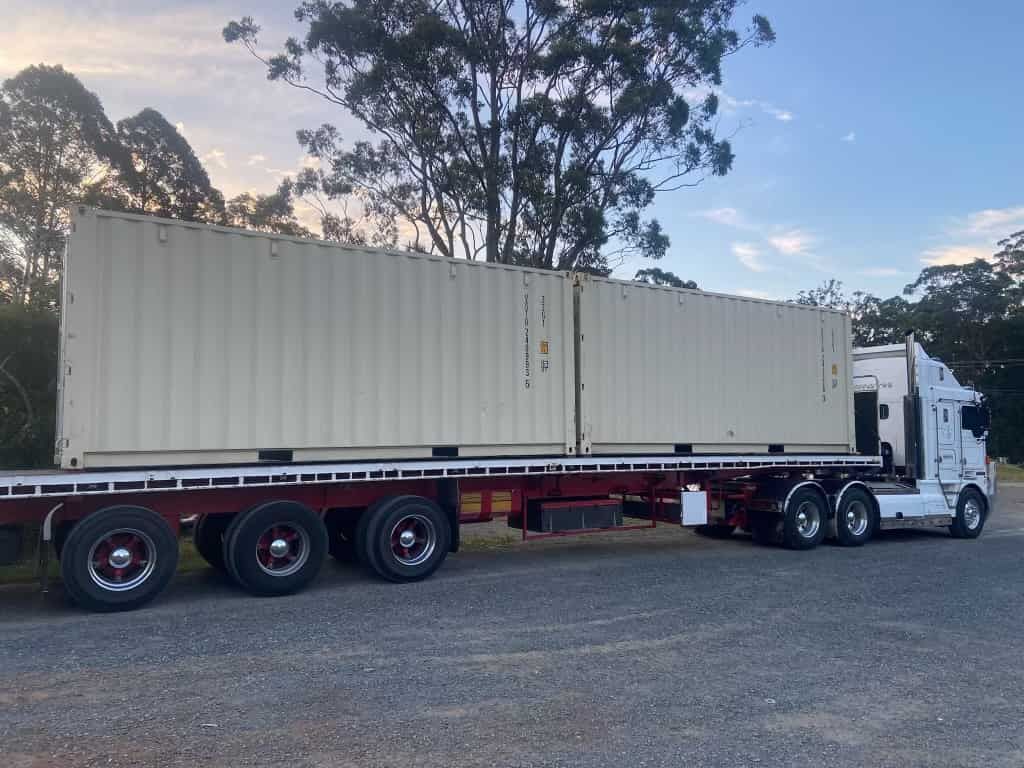A Semi Truck With Two Shipping Containers On The Back Is Parked In A Gravel Lot — TSR Total Shipping Containers In Port Macquarie, NSW