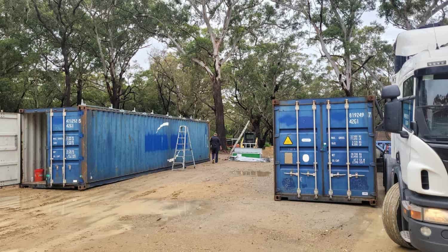 A Truck Is Parked Next To A Row Of Blue Shipping Containers — TSR Total Shipping Containers In Port Macquarie, NSW