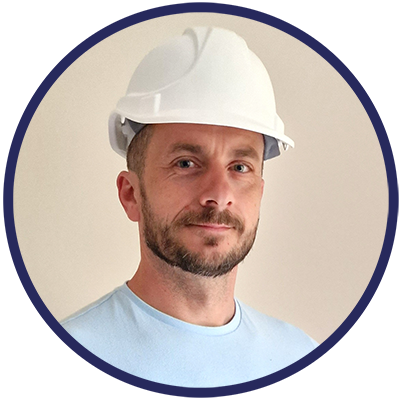 A man with a beard wearing a white hard hat