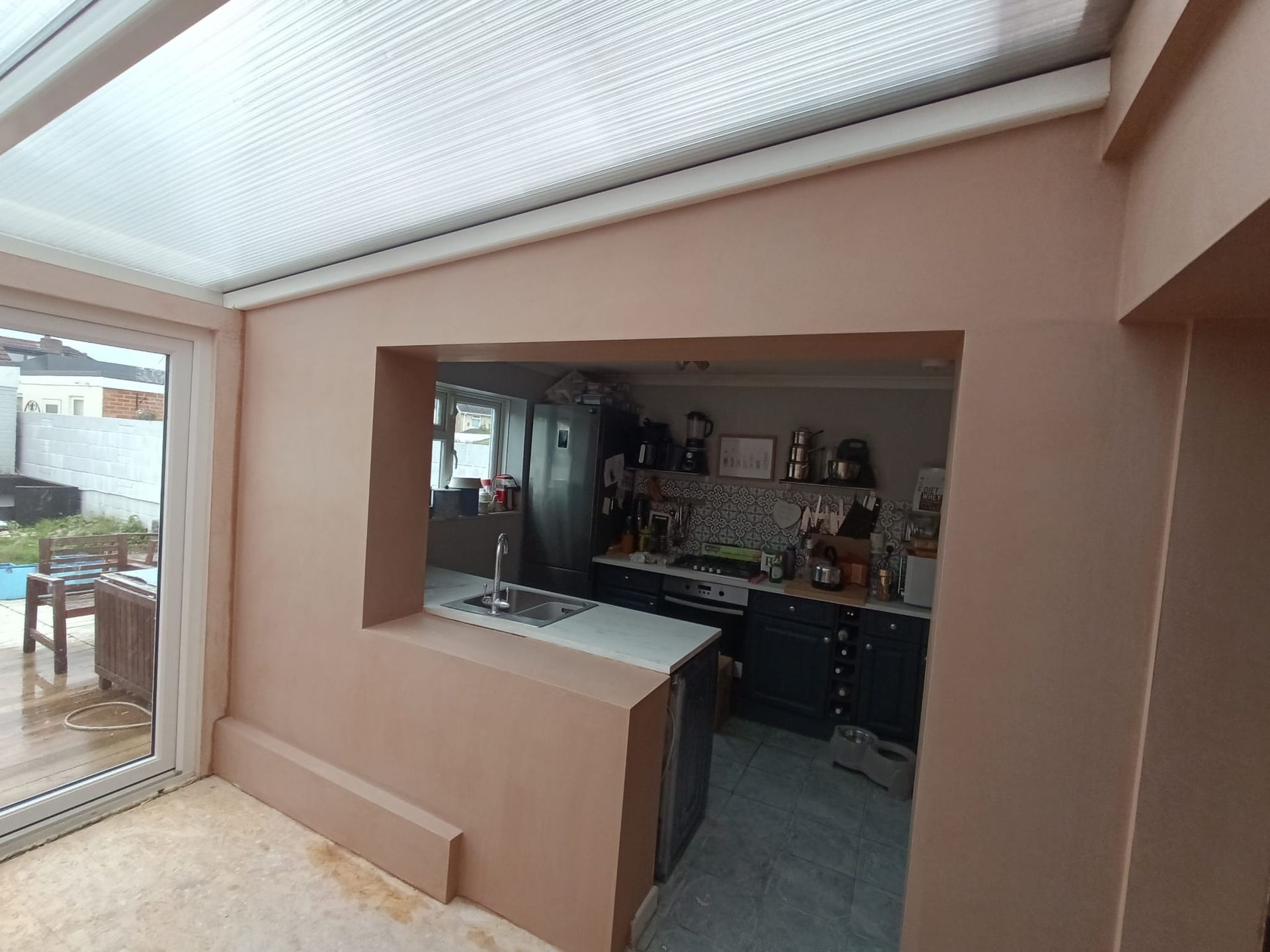 A kitchen with a sliding glass door leading to a patio.
