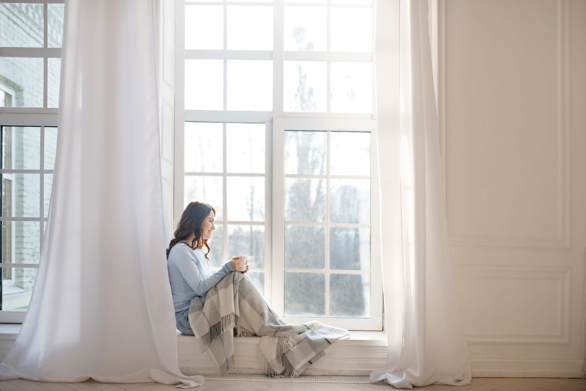 A person sitting quietly near a window in soft light, representing the courage and clarity