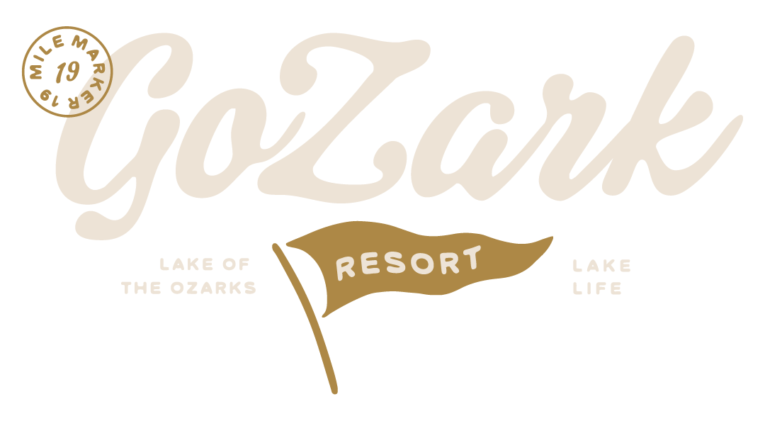 Logo for GoZark Resort at the Lake of the Ozarks, featuring script text and a pennant flag icon in shades of tan and brown.