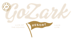 Logo for GoZark Resort at the Lake of the Ozarks, featuring script text and a pennant flag icon in shades of tan and brown.