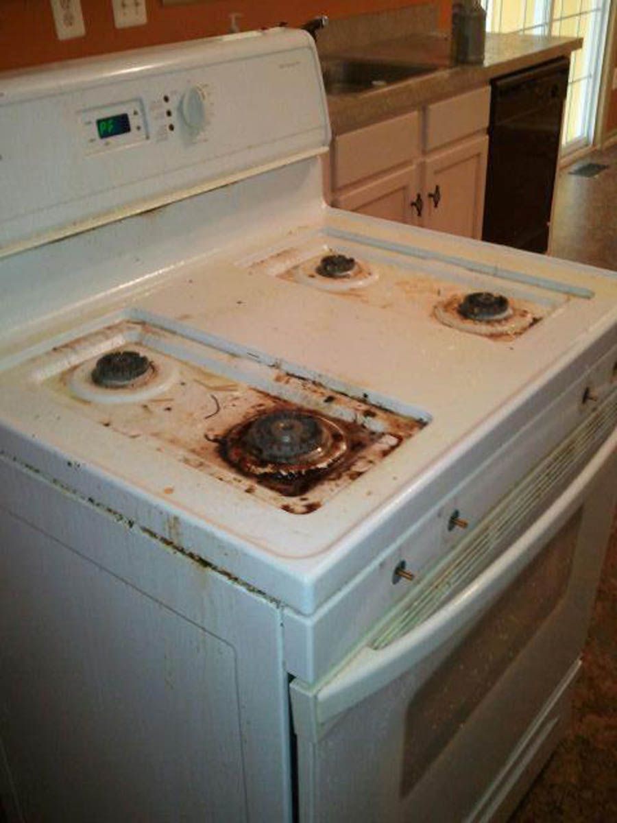White electric stove with visible food stains on the cooktop.