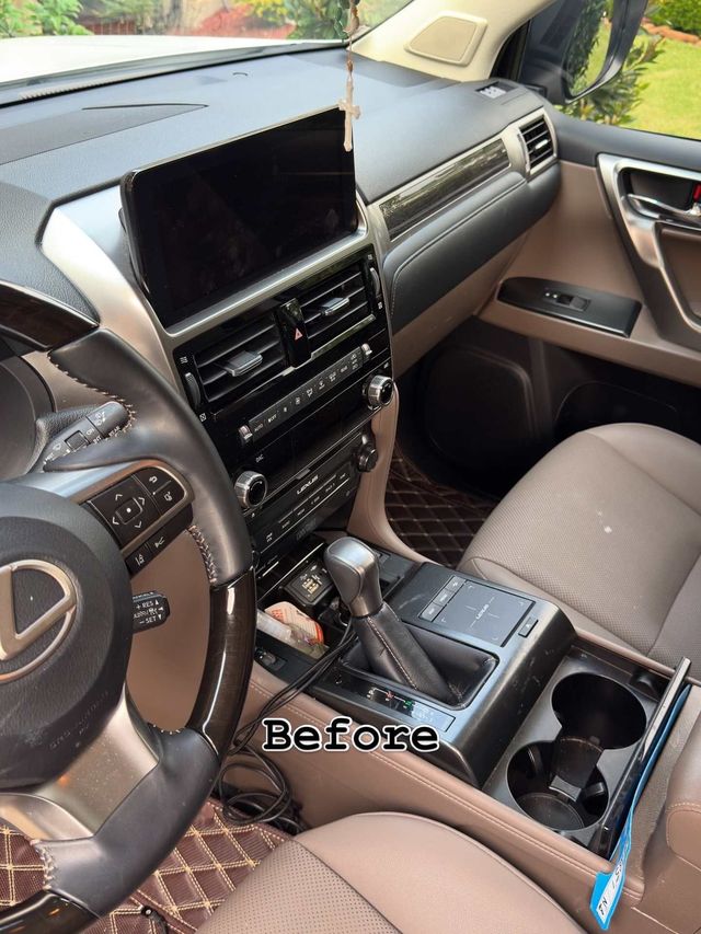 Lexus GX console before detailing with dust and debris, Ongowash mobile detailing serving Houston, TX