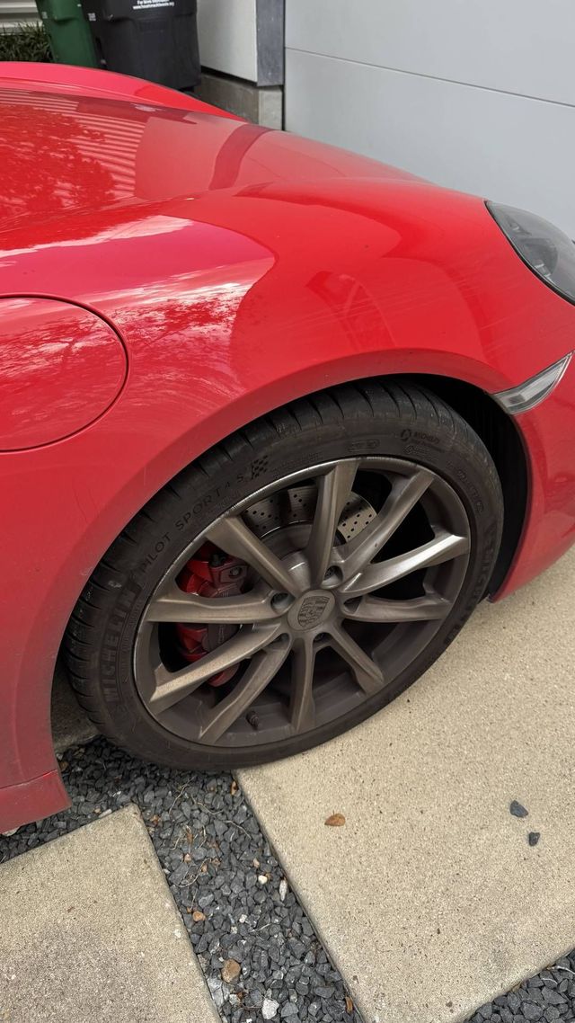 Porsche 718 wheel coated in brake dust before cleaning, Ongowash mobile detailing serving Bellaire, TX