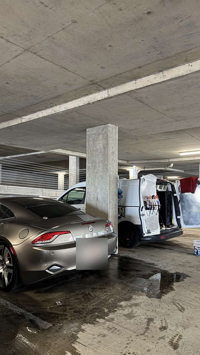 Fisker Karma being detailed in a parking garage next to the Ongowash van, Ongowash mobile detailing serving Manvel, TX