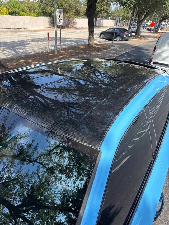 Glossy black roof of a Lamborghini Urus reflecting trees after a wash, Ongowash mobile detailing serving The Woodlands, TX