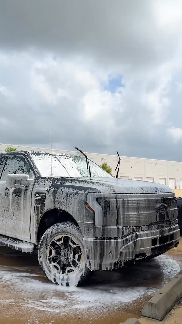 Ford F-150 Lightning covered in foam at a commercial lot, Ongowash mobile detailing serving Missouri City, TX