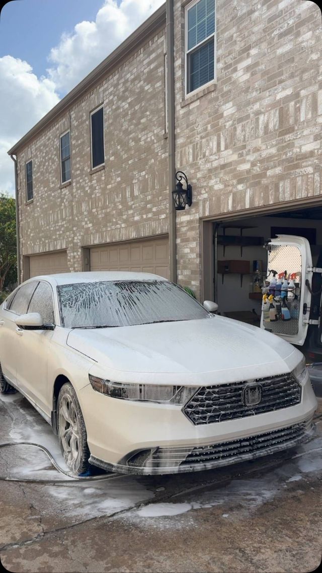 Honda Accord covered in foam in front of a garage, Ongowash mobile detailing serving Sugar Land, TX