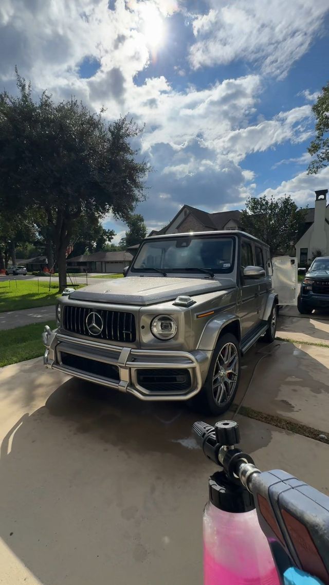 Foam cannon aimed at a Mercedes-AMG G63 in a driveway, Ongowash mobile detailing serving Bellaire, TX