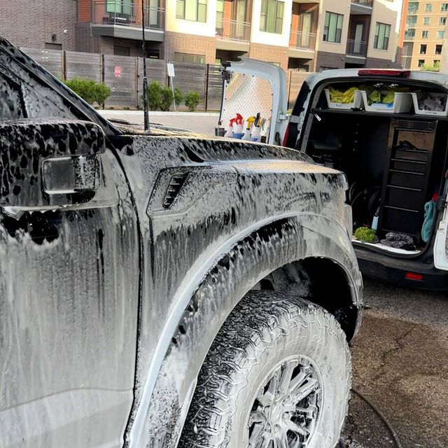Pickup truck covered in foam with the Ongowash van open behind it, Ongowash mobile detailing serving Sugar Land, TX
