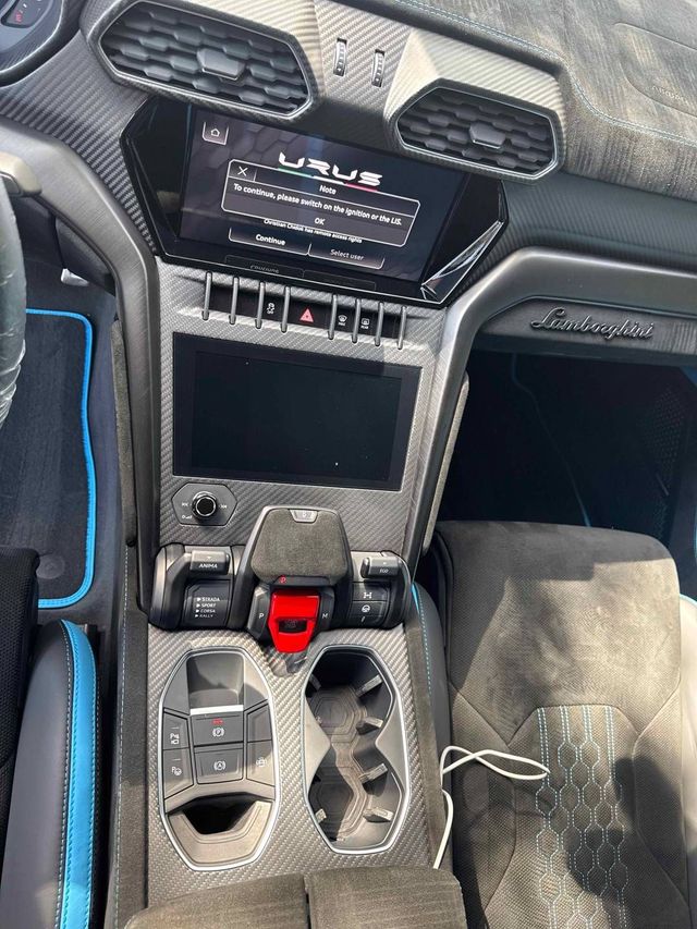 Lamborghini Urus center console and screens wiped clean, Ongowash mobile detailing serving Missouri City, TX