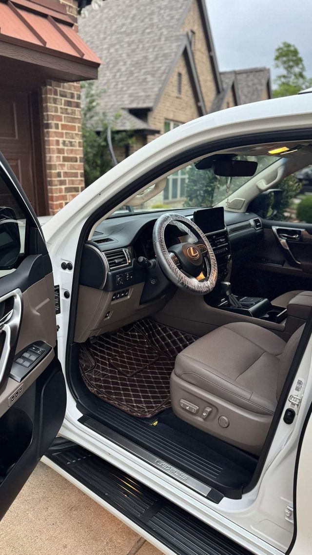 White Lexus GX with front door open showing a clean leather interior, Ongowash mobile detailing serving Cypress, TX