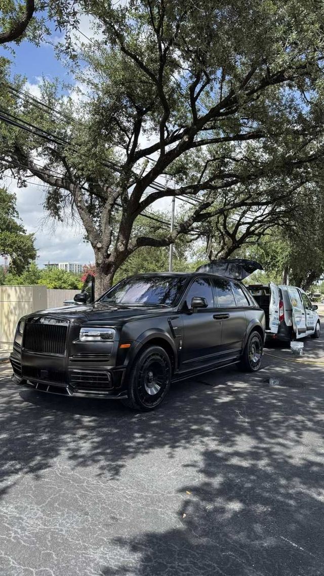 Rolls-Royce Cullinan detailed curbside with the Ongowash van behind it, Ongowash mobile detailing serving Sugar Land, TX