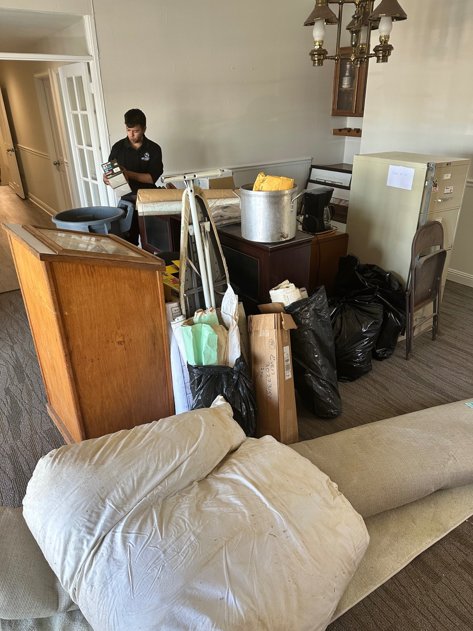 Office filled with junk being hauled away.