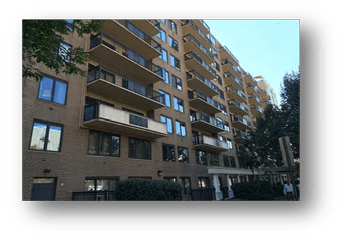 A large apartment building with lots of windows and balconies
