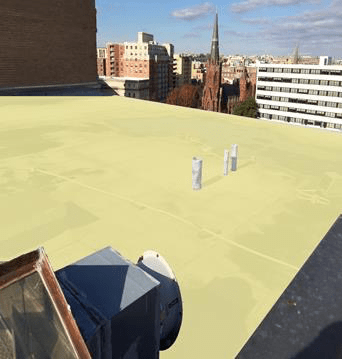 A rooftop view of a city with a camera on it.