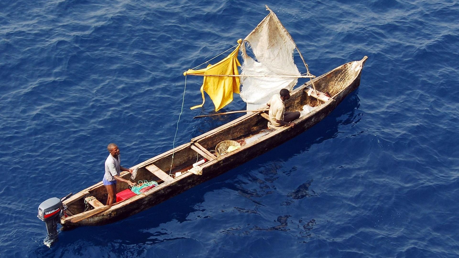 2 men on a wooden boat