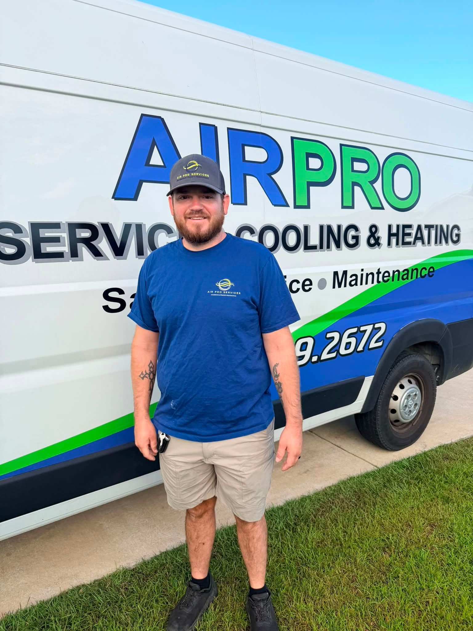 Man standing beside an AIRPRO HVAC service van with blue and green logo.