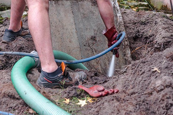 Worker Cleaning The Septic Tank — Erie, PA — Moore Sanitation Worker Cleaning The Septic Tank — Erie, PA — Moore Sanitation