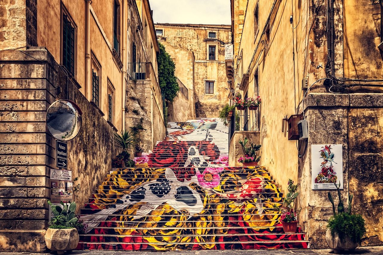 A set of stairs leading up to a building with graffiti on them.