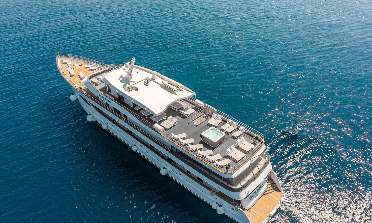 An aerial view of a large yacht floating on top of a body of water.