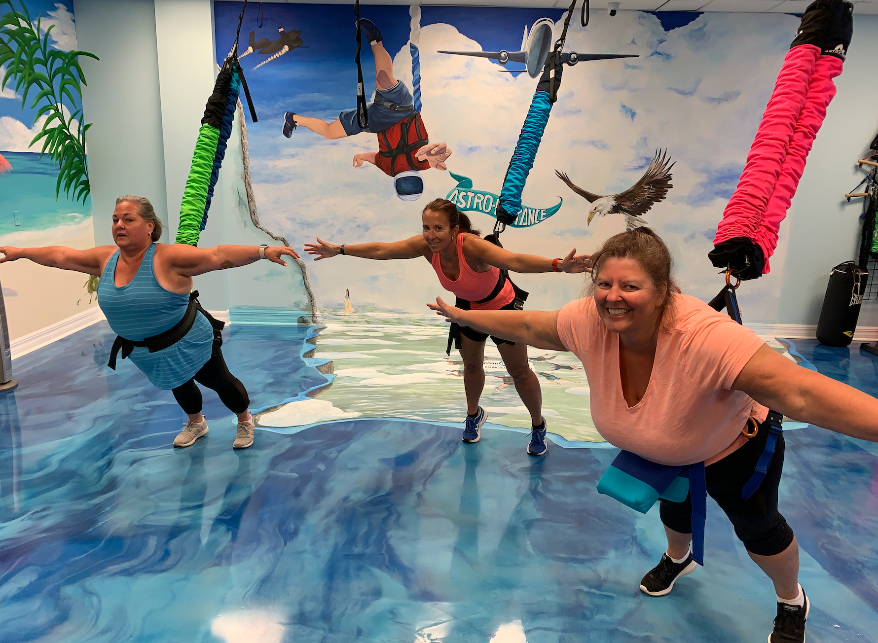 A group of women are doing exercises in a gym.