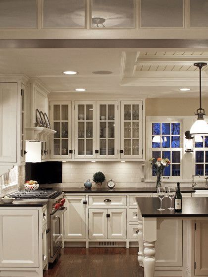 A kitchen with white cabinets and a black counter top - Omaha, NE - BluePrint Construction