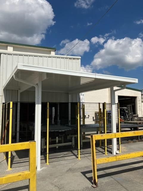 Patio with black aluminum pergola and potted plants — Greenville, SC — Greenville Aluminum