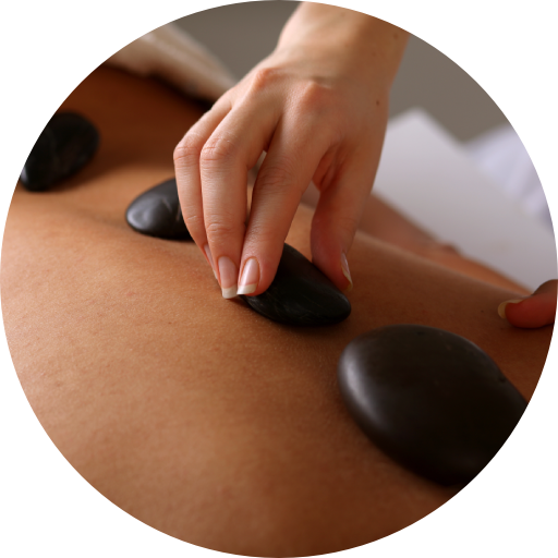 A person getting a massage with rocks on their back