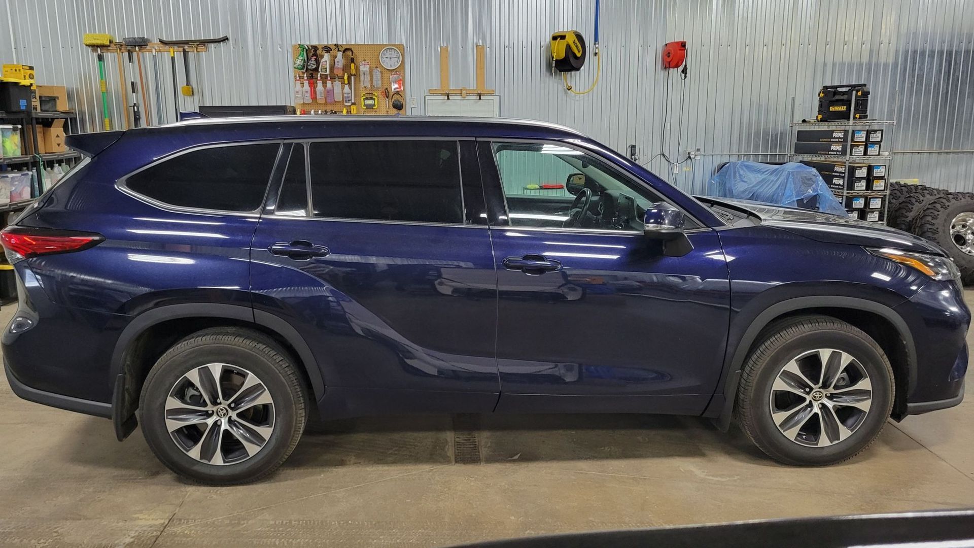 Blue SUV parked inside a garage.