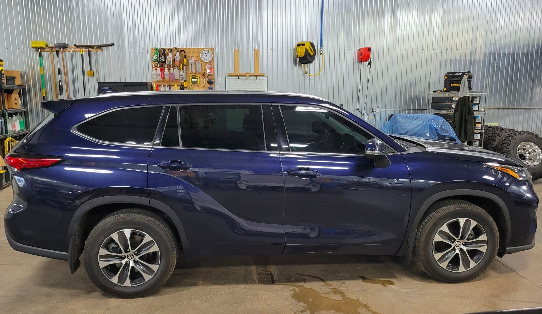 Blue Toyota Highlander SUV parked inside a garage.