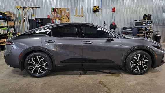 A gray car is parked in a garage.